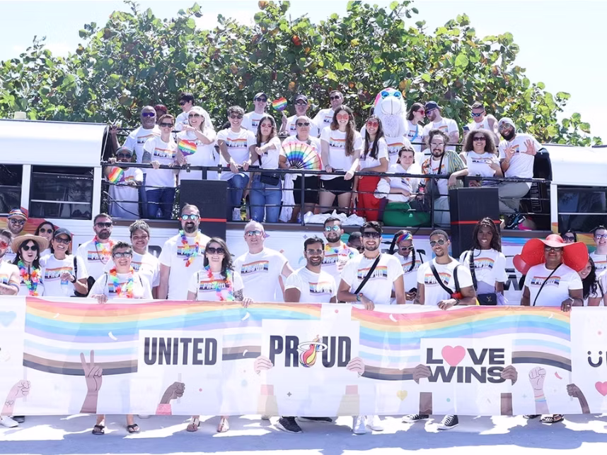 Joyful participants celebrating on Rumbatours open-air party bus during Miami Pride Parade